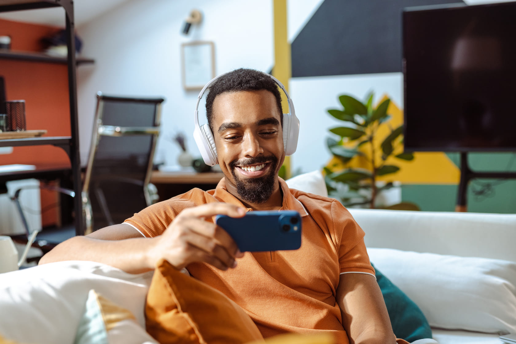 A user enjoying a perfectly curated playlist on Spotify on his phone.